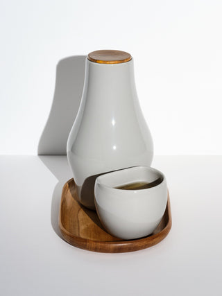 One grey medium cup next to one grey carafe