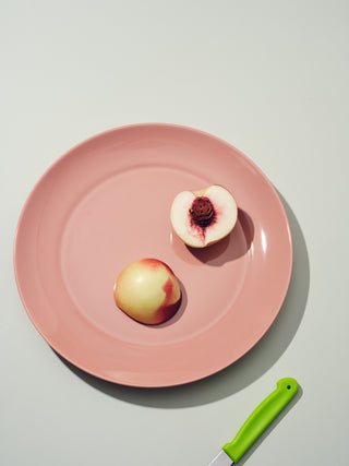 Rose colored dinner plates with two peach halves
