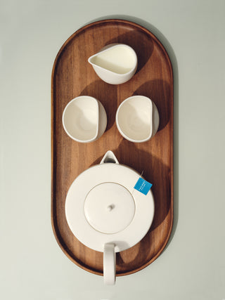 Full tea set on top of large oval wooden tray