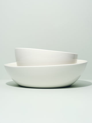 Two nesting asymmetrical serving bowls