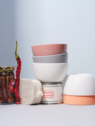 A still life of small ceramic bowls and kitchen items