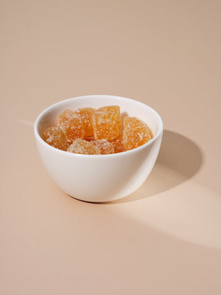A small white ceramic bowl filled with candied ginger