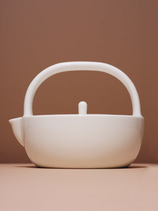 Small white ceramic teapot